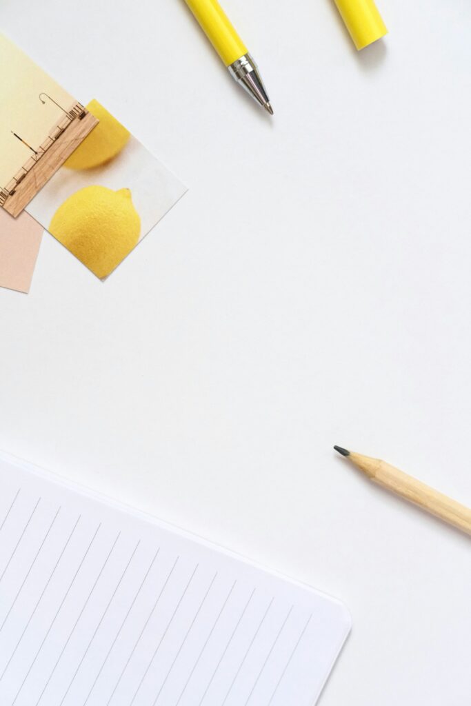 yellow writing tools on a white background